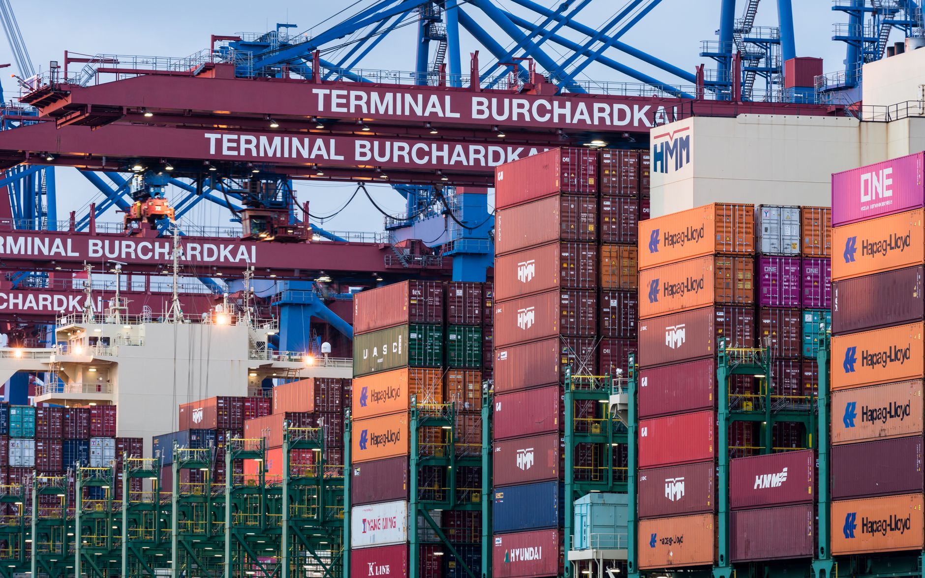 View of shipping containers and cranes at Hamburg's Burchardkai terminal.