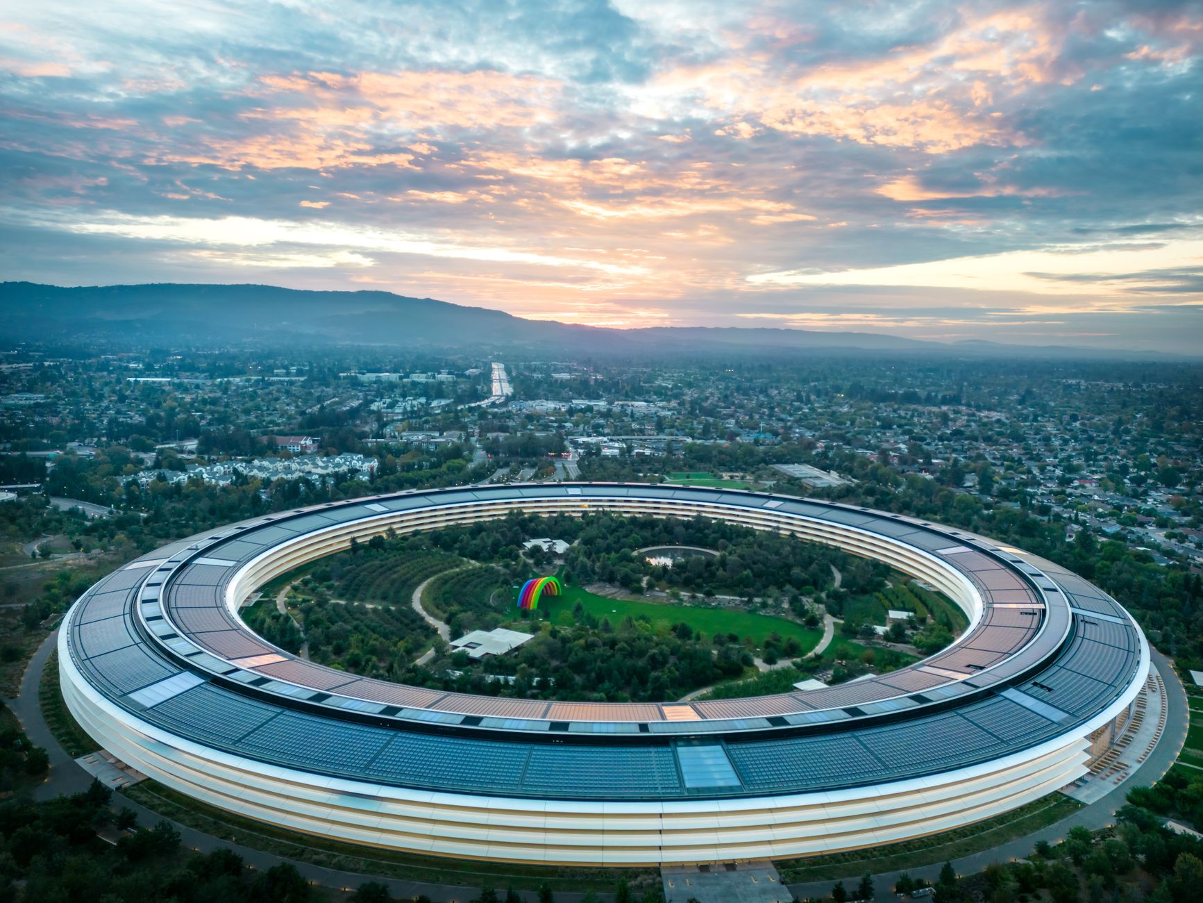 Stunning aerial view of Apple Park in Cupertino, California during a beautiful sunset.