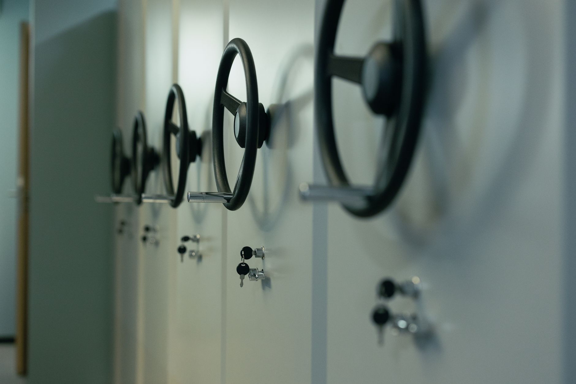 Close-up of industrial safes with manual locks and keys, highlighting security features.