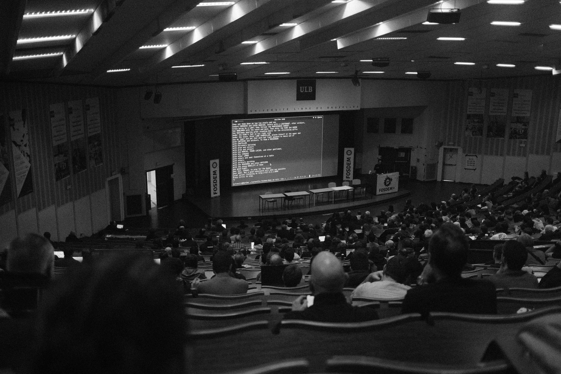 Black and white shot of a technology conference at ULB auditorium, Brussels.