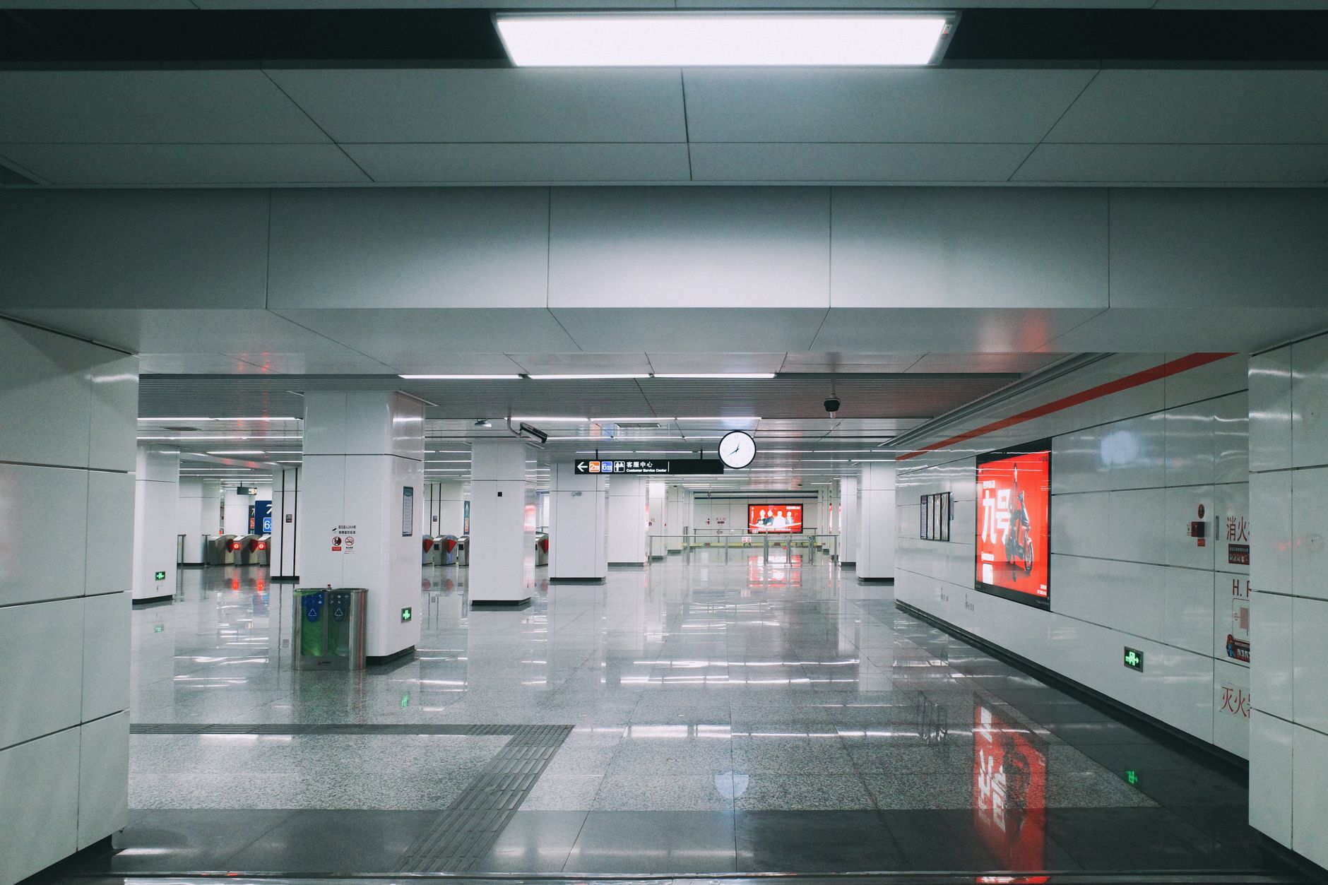 Empty modern subway station with bright lights and clean design, showcasing urban architecture.