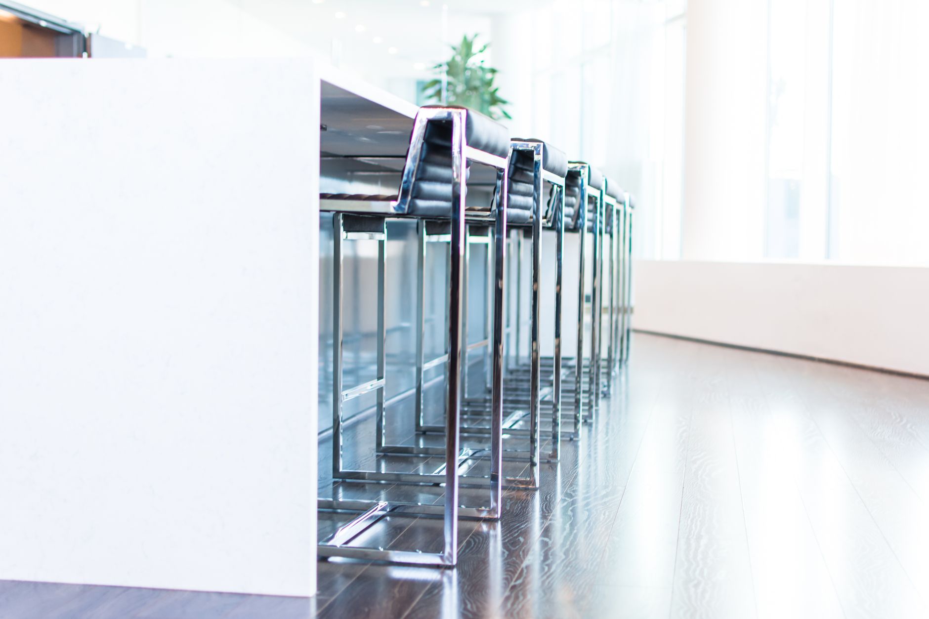 Bright and contemporary office space with modern stools and a minimalist design.